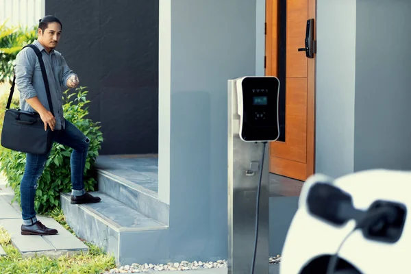 Progressive Asian Man Electric Car Home Charging Station Concept Use — ストック写真