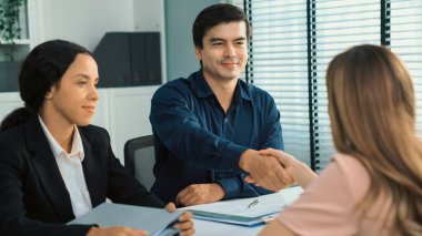 A new and competent female employee successfully interviewed. Newly graduated gets her first job after the interview.
