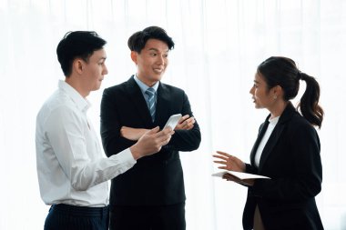 Mentor, manager advice younger colleagues in workplace. Businesspeople discussing or planning financial project strategy, talking together for harmony and strong teamwork in office concept.