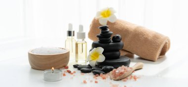 Spa accessory composition set in day spa hotel , beauty wellness center . Spa product are placed in luxury spa resort room , ready for massage therapy from professional service .