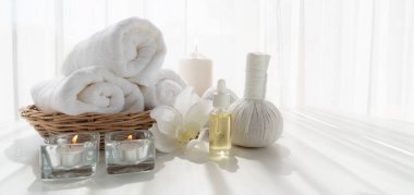 Spa accessory composition set in day spa hotel , beauty wellness center . Spa product are placed in luxury spa resort room , ready for massage therapy from professional service .