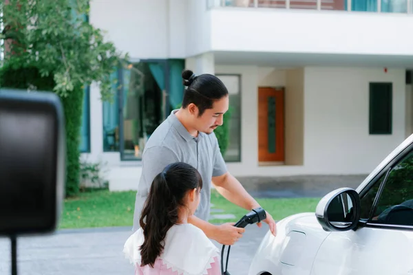 Progressive Father Daughter Returned School Electric Vehicle Being Charged Home — Stock fotografie