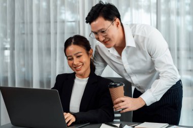 Mentor, manager with coffee advice younger colleagues in workplace. Couple businesspeople discussing financial strategy, working together for harmony and strong teamwork in office concept