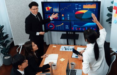 Confidence and asian businessman give presentation on financial analyzed by business intelligence in dashboard report to other people in board room meeting to promote harmony in workplace.