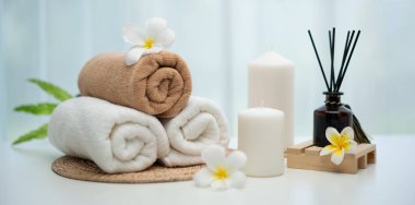 Spa accessory composition set in day spa hotel , beauty wellness center . Spa product are placed in luxury spa resort room , ready for massage therapy from professional service .