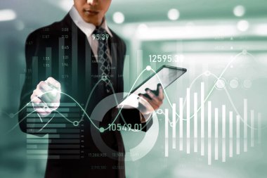 Businessman analyst working with digital finance business data graph showing technology of investment strategy for perceptive financial business decision. Digital economic analysis technology concept.