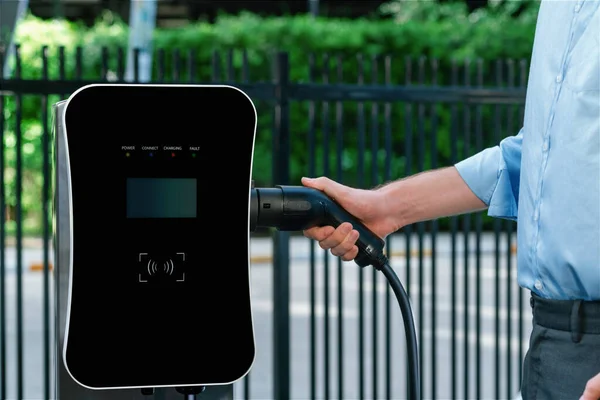 Closeup Progressive Man Holding Charger Plug Public Charging Station Electric — ストック写真
