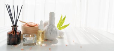 Spa accessory composition set in day spa hotel , beauty wellness center . Spa product are placed in luxury spa resort room , ready for massage therapy from professional service .