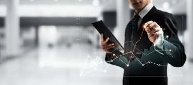 Businessman analyst working with digital finance business data graph showing technology of investment strategy for perceptive financial business decision. Digital economic analysis technology concept.