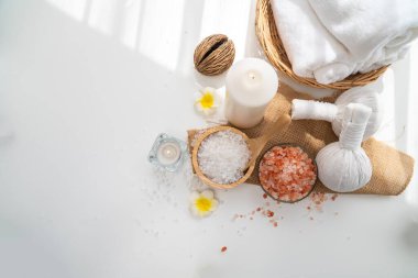 Spa accessory composition set in day spa hotel , beauty wellness center . Spa product are placed in luxury spa resort room , ready for massage therapy from professional service .