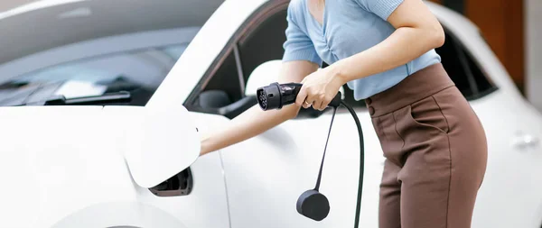 Closeup Progressive Woman Install Cable Plug Her Electric Car Home — Foto de Stock