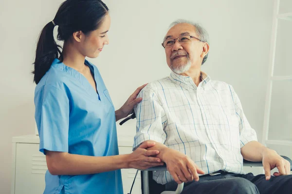 Happy Positive Asian Nurse Giving Support Touching Contented Senior Man — Foto Stock