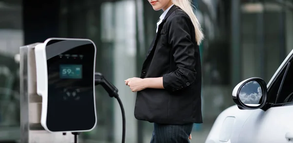 Progressive Businesswoman Insert Charger Plug Charging Station Her Electric Vehicle — Stockfoto