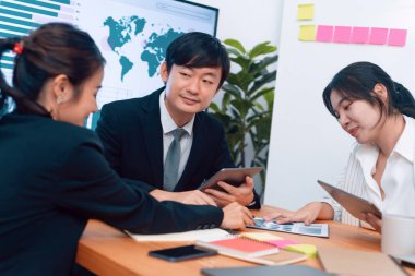 Business team of financial data analysis meeting with business intelligence, report paper and dashboard on laptop for marketing strategy. Business people working together to promote harmony in office.