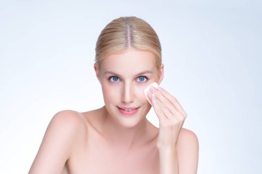 Personable beautiful natural soft makeup woman using powder puff for facial makeup concept. Cushion foundation applying on young girl face in isolated background.