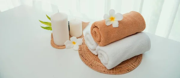 Spa accessory composition set in day spa hotel , beauty wellness center . Spa product are placed in luxury spa resort room , ready for massage therapy from professional service .