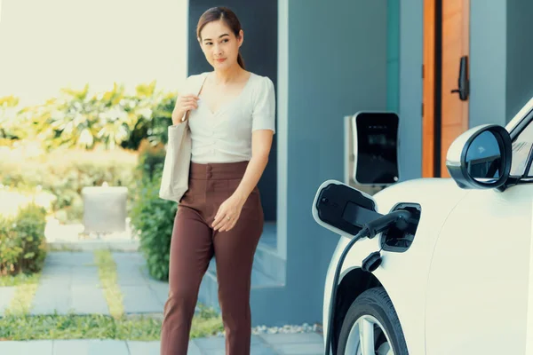 Progressive Asian Woman Electric Car Home Charging Station Concept Use — Stock fotografie