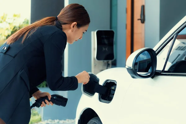Progressive Woman Install Cable Plug Her Electric Car Home Charging — 스톡 사진