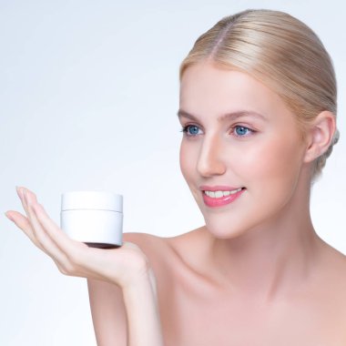 Personable beautiful perfect natural skin woman hold mockup tube moisturizer cream for skincare treatment product advertisement in isolated background with expressive facial and gesture expression.