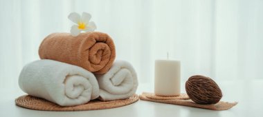 Spa accessory composition set in day spa hotel , beauty wellness center . Spa product are placed in luxury spa resort room , ready for massage therapy from professional service .