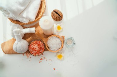 Spa accessory composition set in day spa hotel , beauty wellness center . Spa product are placed in luxury spa resort room , ready for massage therapy from professional service .