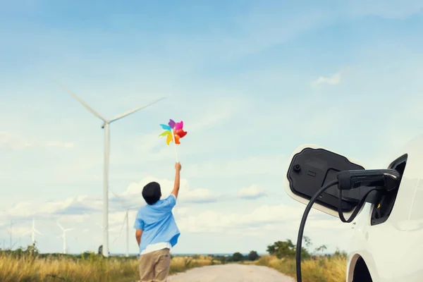 Progressive Young Asian Boy Playing Wind Pinwheel Toy Wind Turbine — Stok fotoğraf