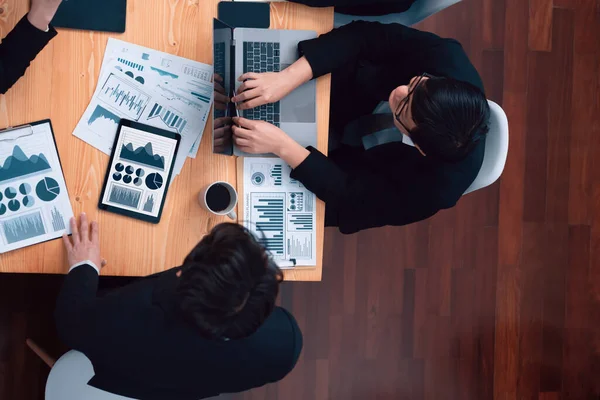 stock image Top-view business team of financial data analysis meeting with business intelligence, report paper and dashboard on laptop for marketing strategy. Business people working together in office of harmony