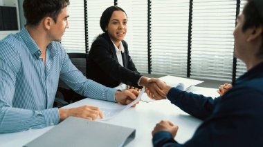 Commercial contract signed by competent people of various ethnicities and shake hands. Trade agreements, two-party business transactions.