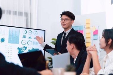 Confidence and asian businessman give presentation on financial analyzed by business intelligence in dashboard report to other people in board room meeting to promote harmony in workplace.
