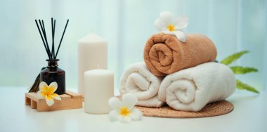 Spa accessory composition set in day spa hotel , beauty wellness center . Spa product are placed in luxury spa resort room , ready for massage therapy from professional service .