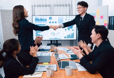 Businesspeople shake hand after successful agreement or meeting. Office worker colleague handshake with business team leader manager for strong teamwork in office to promote harmony and unity concept.