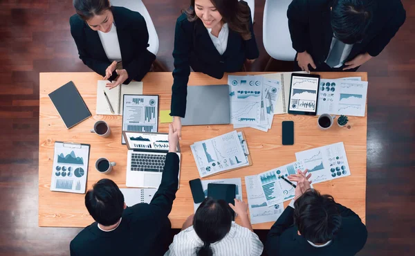 Top-view business team of financial data analysis meeting with business intelligence, report paper and dashboard on laptop for marketing strategy. Business people working together in office of harmony