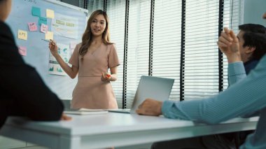 Competent office workers from various nationalities are debating, discussing and brainstorming in the meeting room. A group of employees is collaborating to achieve their business objectives.