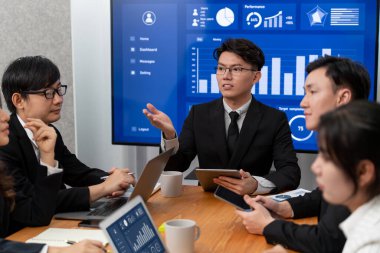 Business team of financial data analysis meeting with business intelligence, report paper and dashboard on laptop for marketing strategy. Business people working together to promote harmony in office.