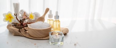 Spa accessory composition set in day spa hotel , beauty wellness center . Spa product are placed in luxury spa resort room , ready for massage therapy from professional service .