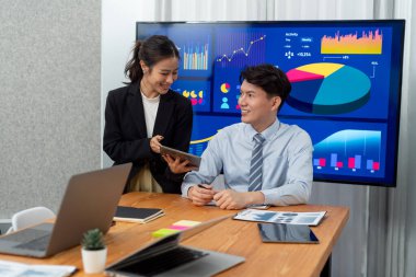 Business team of financial data analysis meeting with business intelligence, report paper and dashboard on laptop for marketing strategy. Business people working together to promote harmony in office.