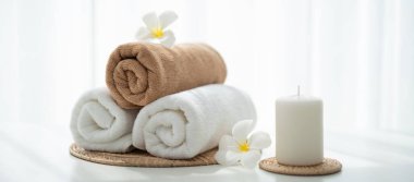 Spa accessory composition set in day spa hotel , beauty wellness center . Spa product are placed in luxury spa resort room , ready for massage therapy from professional service .