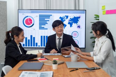 Business team of financial data analysis meeting with business intelligence, report paper and dashboard on laptop for marketing strategy. Business people working together to promote harmony in office.