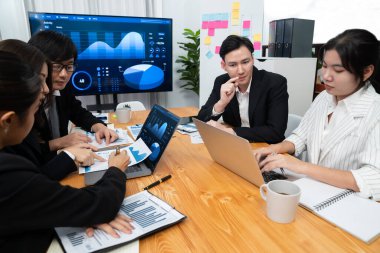 Business team of financial data analysis meeting with business intelligence, report paper and dashboard on laptop for marketing strategy. Business people working together to promote harmony in office.