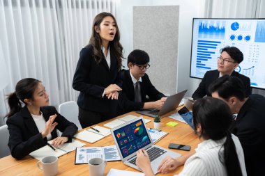 Business team of financial data analysis meeting with business intelligence, report paper and dashboard on laptop for marketing strategy. Business people working together to promote harmony in office.