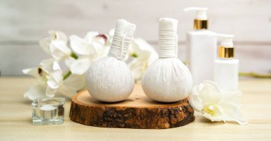 Spa accessory composition set in day spa hotel , beauty wellness center . Spa product are placed in luxury spa resort room , ready for massage therapy from professional service .