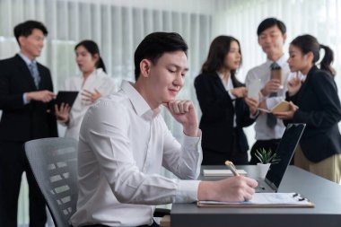 Portrait of focus young successful confident male manager, executive wearing business wear in harmony office arm crossed with blurred meeting background of colleagues, office worker.