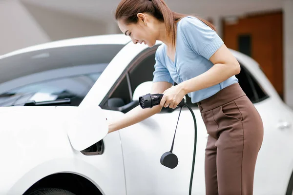 Progressive Woman Install Cable Plug Her Electric Car Home Charging — Stock Photo, Image