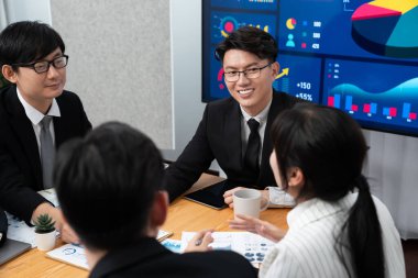 Business team of financial data analysis meeting with business intelligence, report paper and dashboard on laptop for marketing strategy. Business people working together to promote harmony in office.