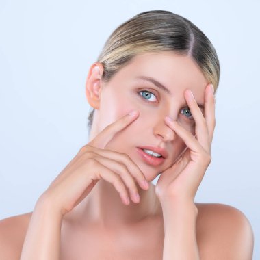 Alluring beautiful woman with perfect smooth and clean skin portrait in isolated background. Beauty hand gesture with expressive facial expression for skincare treatment product or spa.