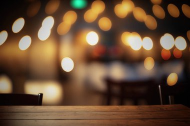 Empty wood table for product display in blur background of admirable restaurant at night
