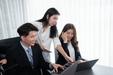 Harmony in office concept as business people analyzing dashboard paper together in workplace. Young colleagues give ideas at manager desk for discussion or strategy planning about project.