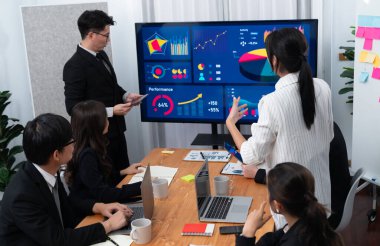 Confidence and asian businessman give presentation on financial analyzed by business intelligence in dashboard report to other people in board room meeting to promote harmony in workplace. clipart