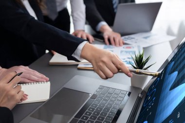 Business team analyze business analytic or business intelligence dashboard on laptop screen show graph and chart with statistic in harmony office. Analyst team meeting researching, planning strategy.