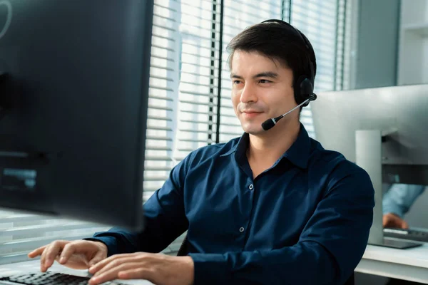 Young Competent Asian Male Call Center Agent Working His Computer — 图库照片